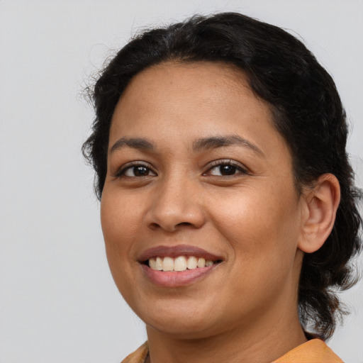 Joyful latino young-adult female with medium  brown hair and brown eyes