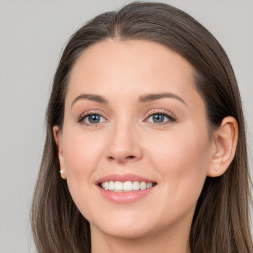 Joyful white young-adult female with long  brown hair and grey eyes