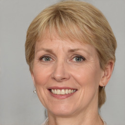 Joyful white adult female with medium  brown hair and grey eyes