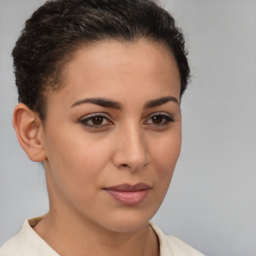 Joyful latino young-adult female with short  brown hair and brown eyes