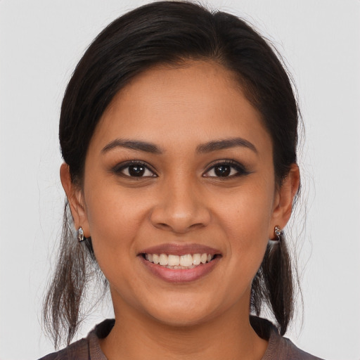 Joyful latino young-adult female with long  brown hair and brown eyes