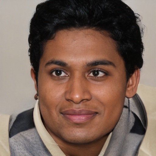 Joyful latino young-adult male with short  black hair and brown eyes