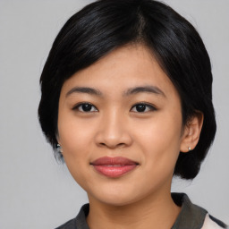 Joyful asian young-adult female with medium  black hair and brown eyes