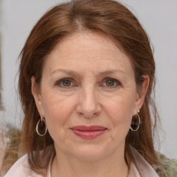 Joyful white adult female with medium  brown hair and grey eyes