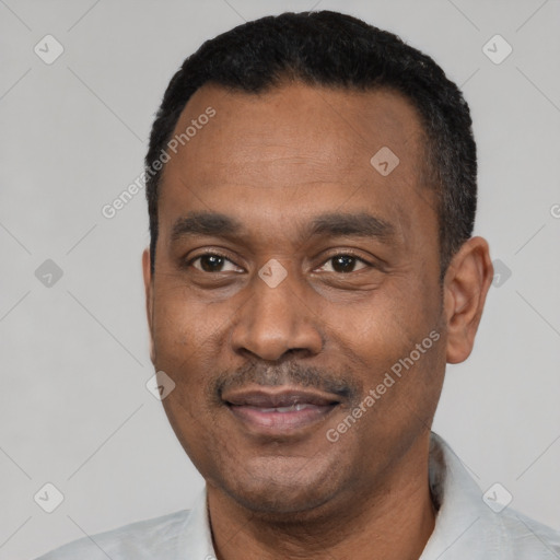 Joyful latino adult male with short  black hair and brown eyes