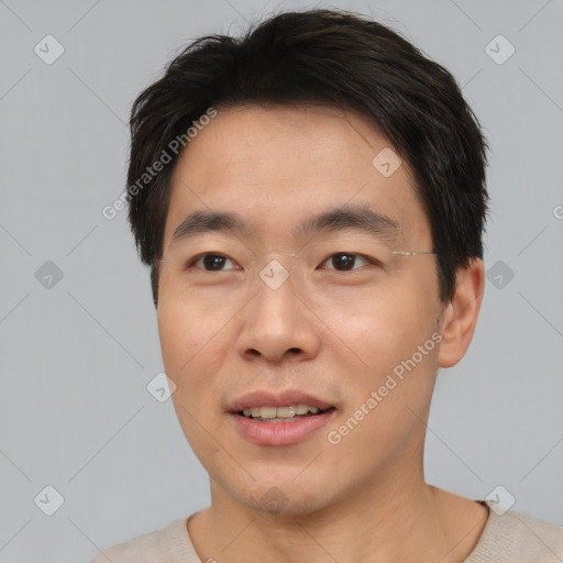 Joyful asian young-adult male with short  brown hair and brown eyes