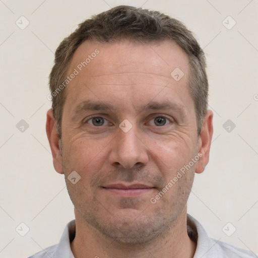 Joyful white adult male with short  brown hair and brown eyes