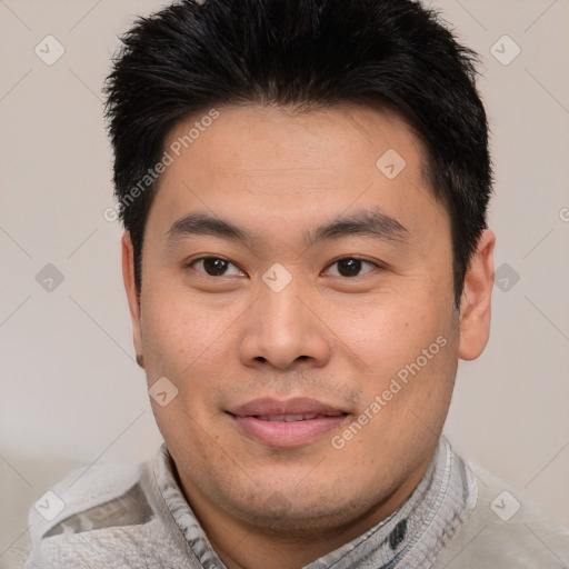 Joyful asian young-adult male with short  black hair and brown eyes