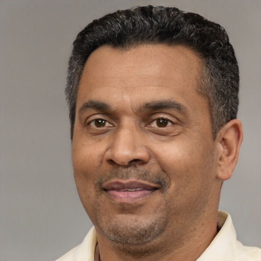 Joyful latino adult male with short  black hair and brown eyes
