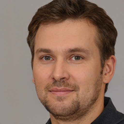 Joyful white adult male with short  brown hair and brown eyes