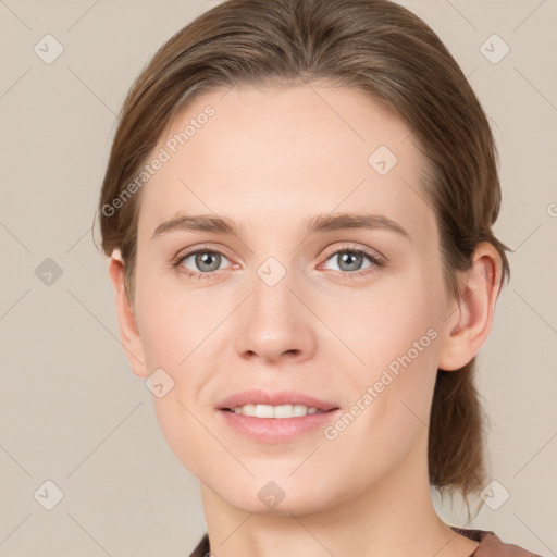 Joyful white young-adult female with medium  brown hair and grey eyes