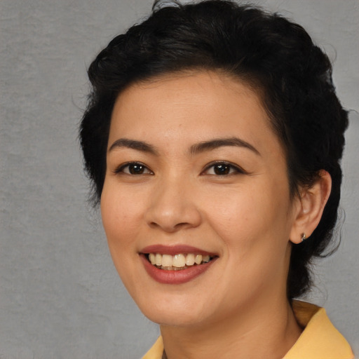 Joyful asian young-adult female with medium  black hair and brown eyes