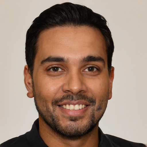 Joyful latino young-adult male with short  black hair and brown eyes