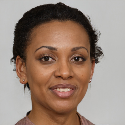 Joyful latino adult female with short  brown hair and brown eyes