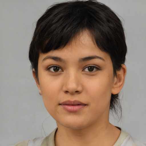 Joyful asian young-adult female with short  brown hair and brown eyes