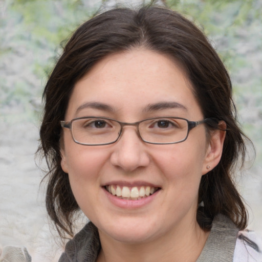 Joyful white adult female with medium  brown hair and grey eyes