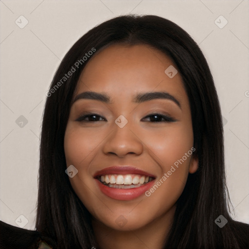 Joyful latino young-adult female with long  black hair and brown eyes