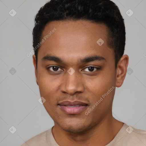 Joyful black young-adult male with short  black hair and brown eyes