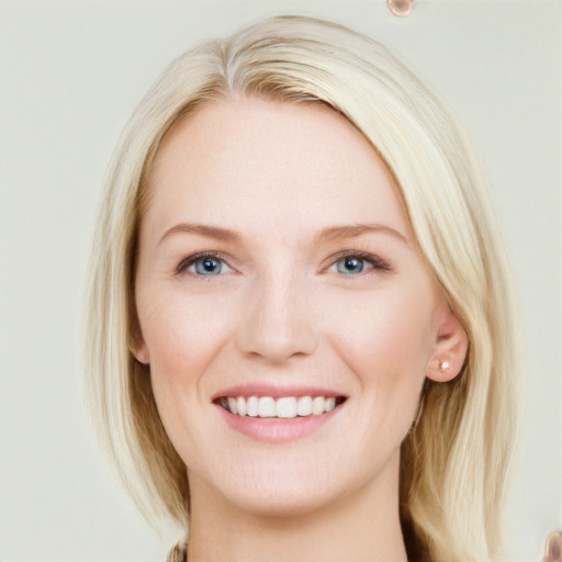 Joyful white young-adult female with long  brown hair and blue eyes