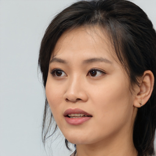 Joyful asian young-adult female with medium  brown hair and brown eyes