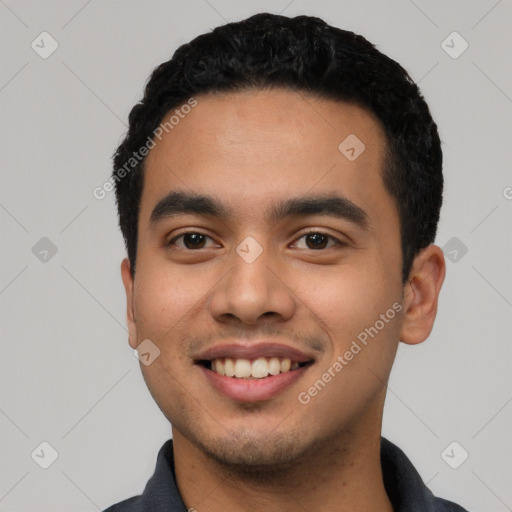 Joyful latino young-adult male with short  black hair and brown eyes