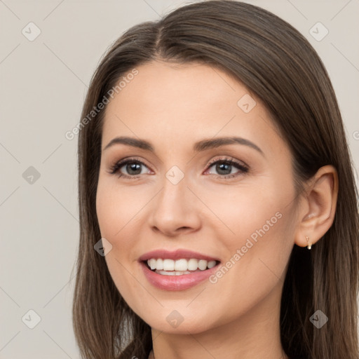 Joyful white young-adult female with long  brown hair and brown eyes