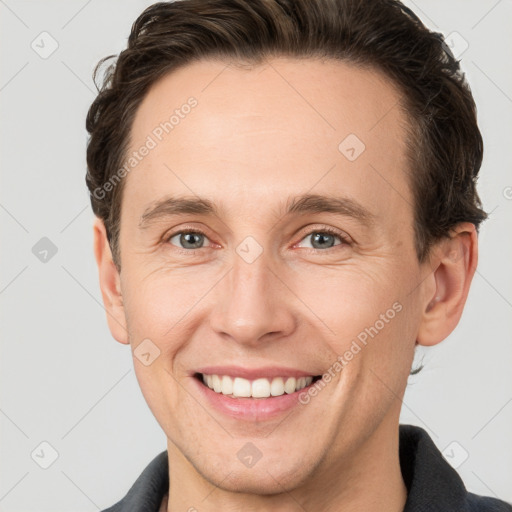 Joyful white adult male with short  brown hair and grey eyes