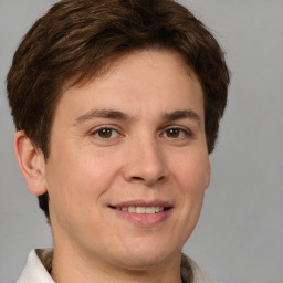 Joyful white adult male with short  brown hair and brown eyes