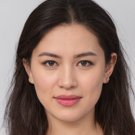Joyful white young-adult female with long  brown hair and brown eyes