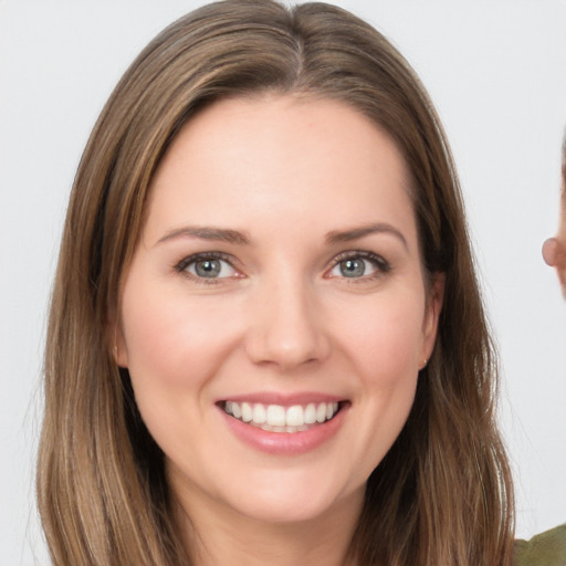 Joyful white young-adult female with long  brown hair and brown eyes