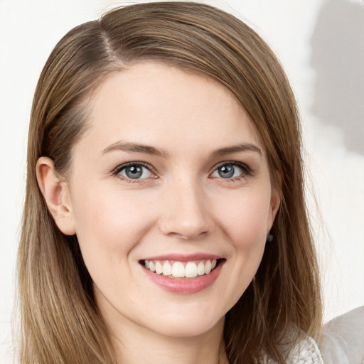 Joyful white young-adult female with long  brown hair and grey eyes