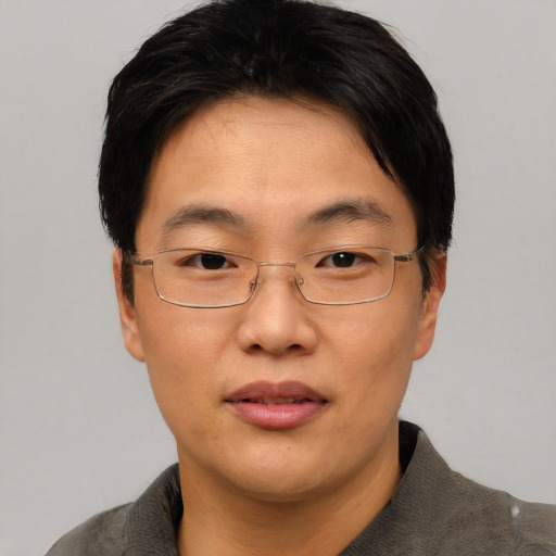 Joyful asian adult male with short  black hair and brown eyes