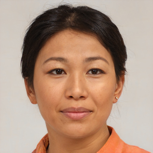 Joyful asian adult female with short  brown hair and brown eyes