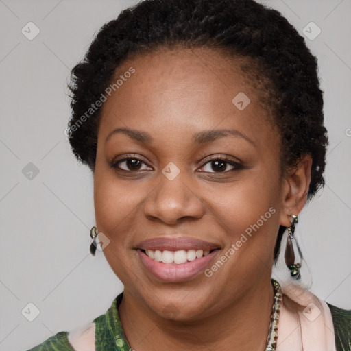 Joyful black young-adult female with long  brown hair and brown eyes