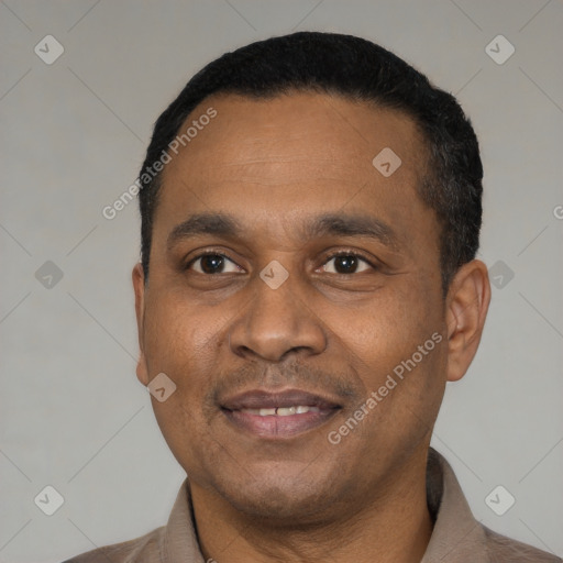 Joyful latino adult male with short  black hair and brown eyes