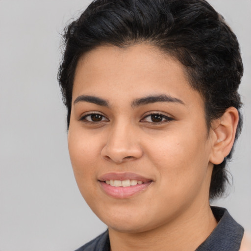 Joyful latino young-adult female with medium  brown hair and brown eyes