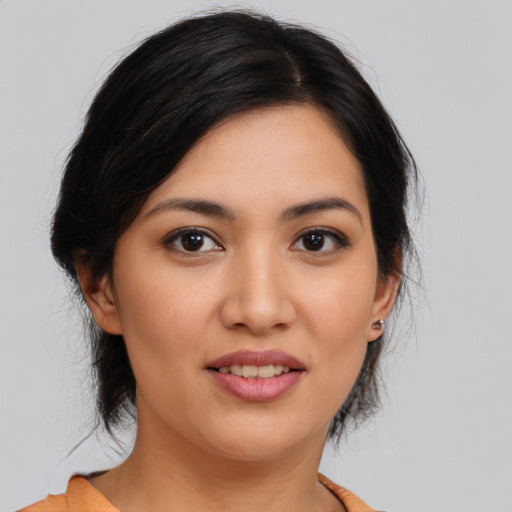 Joyful asian young-adult female with medium  brown hair and brown eyes