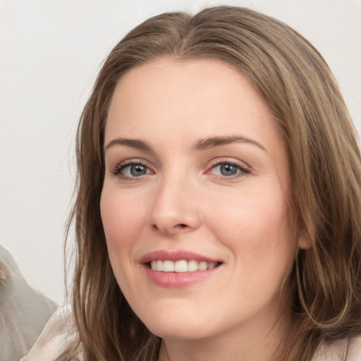 Joyful white young-adult female with long  brown hair and grey eyes