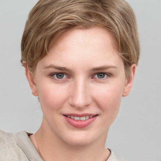 Joyful white young-adult female with short  brown hair and grey eyes