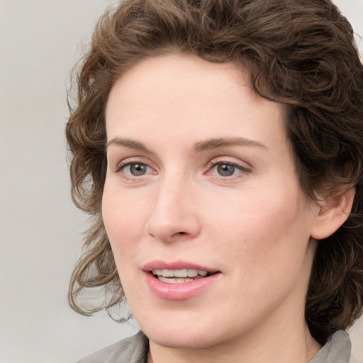 Joyful white young-adult female with medium  brown hair and blue eyes