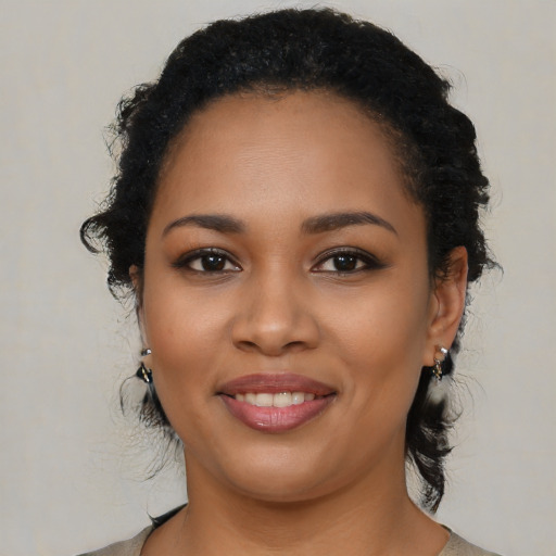 Joyful latino young-adult female with medium  black hair and brown eyes