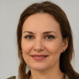 Joyful white adult female with medium  brown hair and green eyes