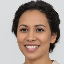 Joyful latino young-adult female with long  brown hair and brown eyes