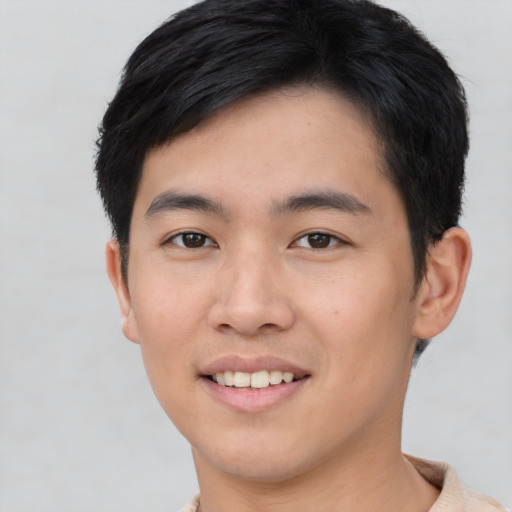 Joyful asian young-adult male with short  black hair and brown eyes