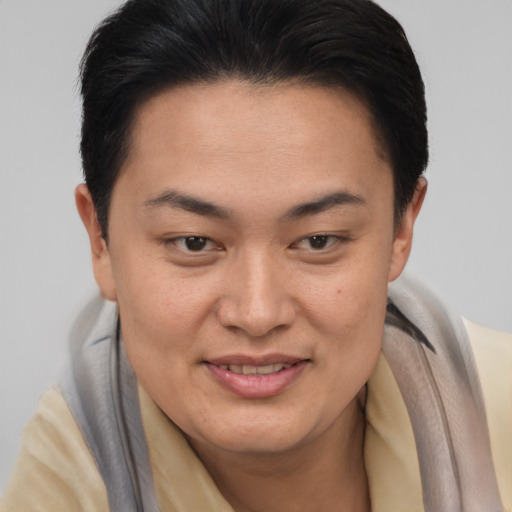 Joyful asian young-adult female with short  brown hair and brown eyes