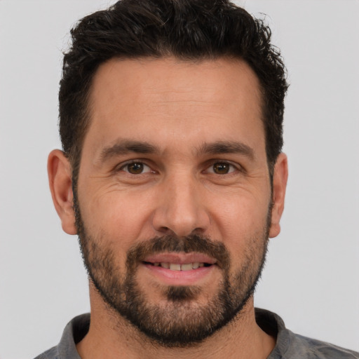 Joyful white adult male with short  brown hair and brown eyes