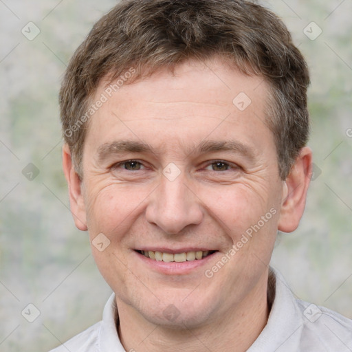 Joyful white adult male with short  brown hair and brown eyes