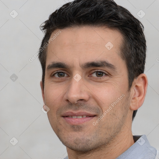 Joyful white young-adult male with short  black hair and brown eyes