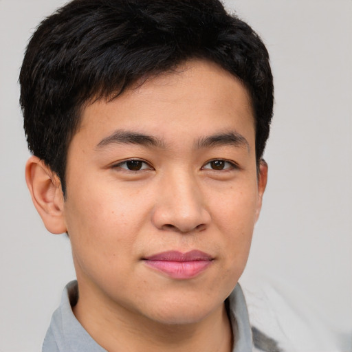 Joyful asian young-adult male with short  brown hair and brown eyes