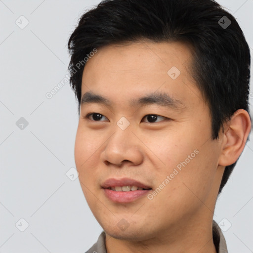 Joyful asian young-adult male with short  black hair and brown eyes